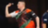 Nick Kenny playing darts while representing Wales.
