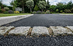 Close up of integrated cobble apron on tarmac driveway.