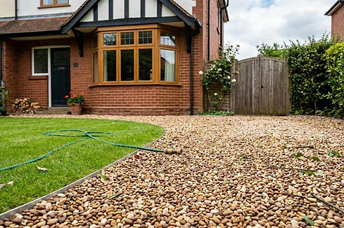 A classic 1930s suburban driveway in Llanishen using multi-coloured pea shingle with a decorative curved garden lawn edge.