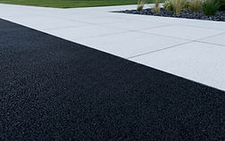 Close up of silver grey pave-edge on tarmac driveway.