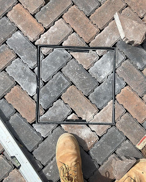 close up of brick paving going over a drainage system