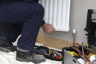 man fitting a radiator