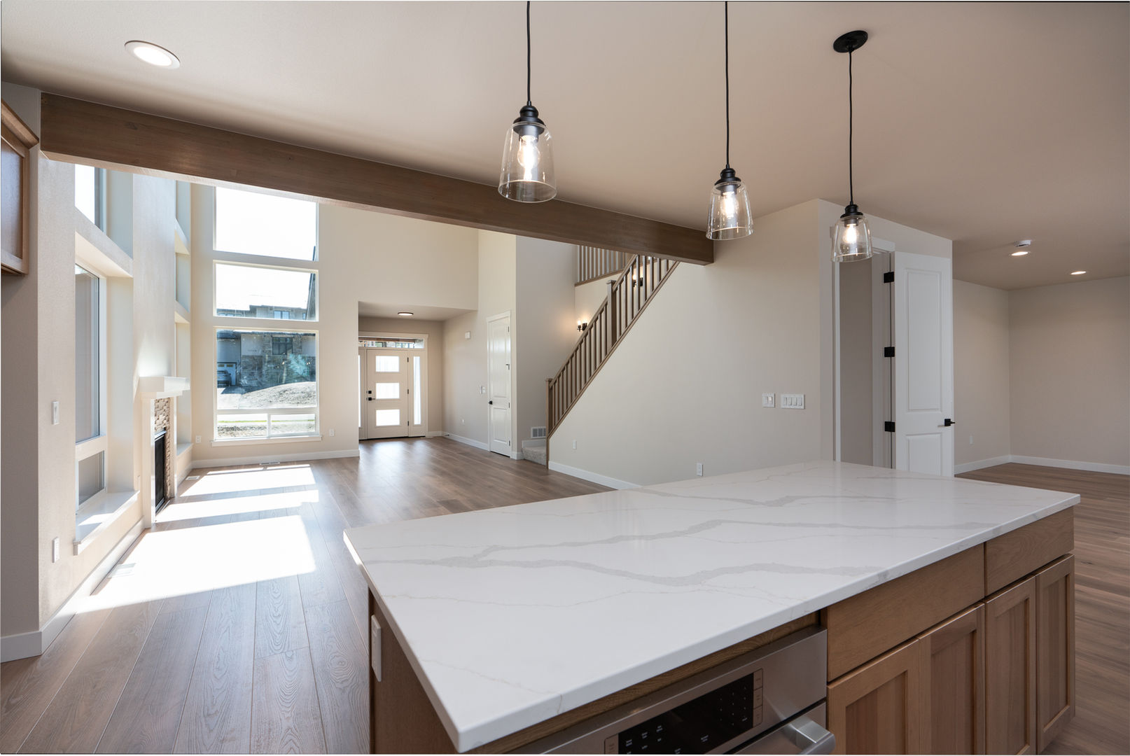 View of two story living room from kitchen in new construction home in Anchorage Alaska