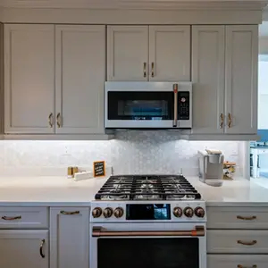 Butterscothe Kitchen with Brass Hardware and White Appliances