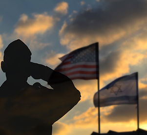 Silhouette of a soldier against the backdrop of the US flag and the flag of Israel. Soldie