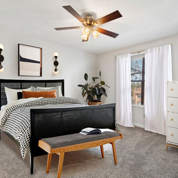 Bedroom with black bed, art, dresser, and bench; modern decor Photos.