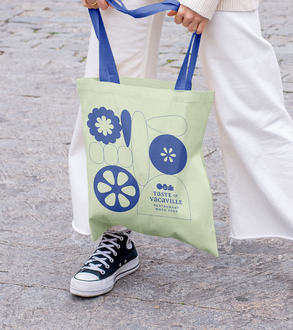 person standing legs apart in white pants and converse holding tote bag with blue straps and printed