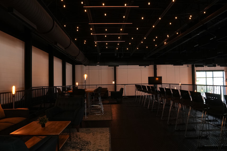 Modern church venue with exposed structural elements and string lighting