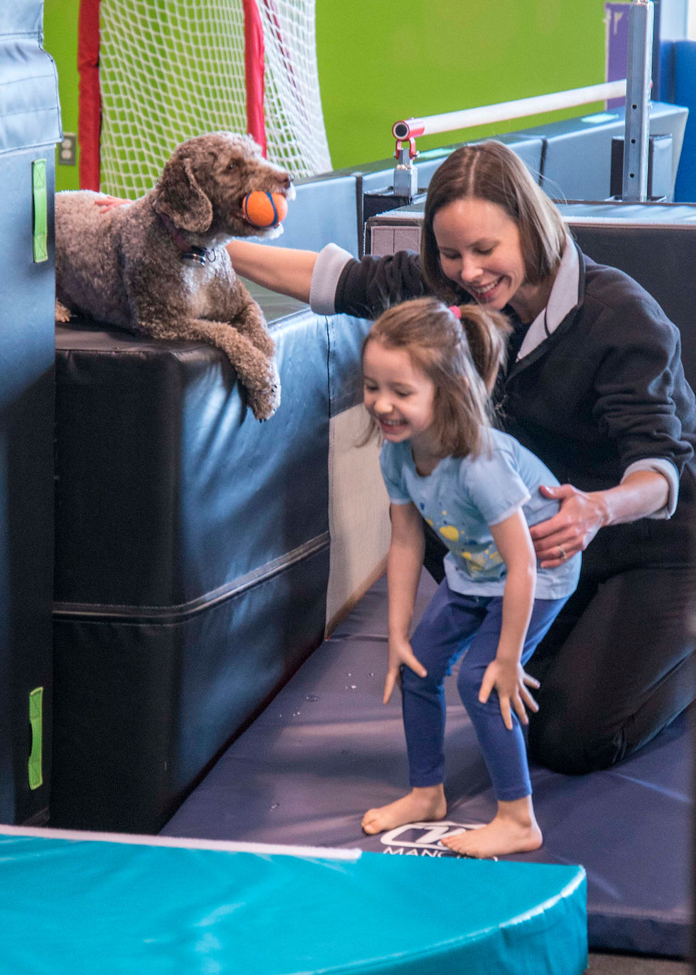 Therapist assisting a child in pediatric therapy session