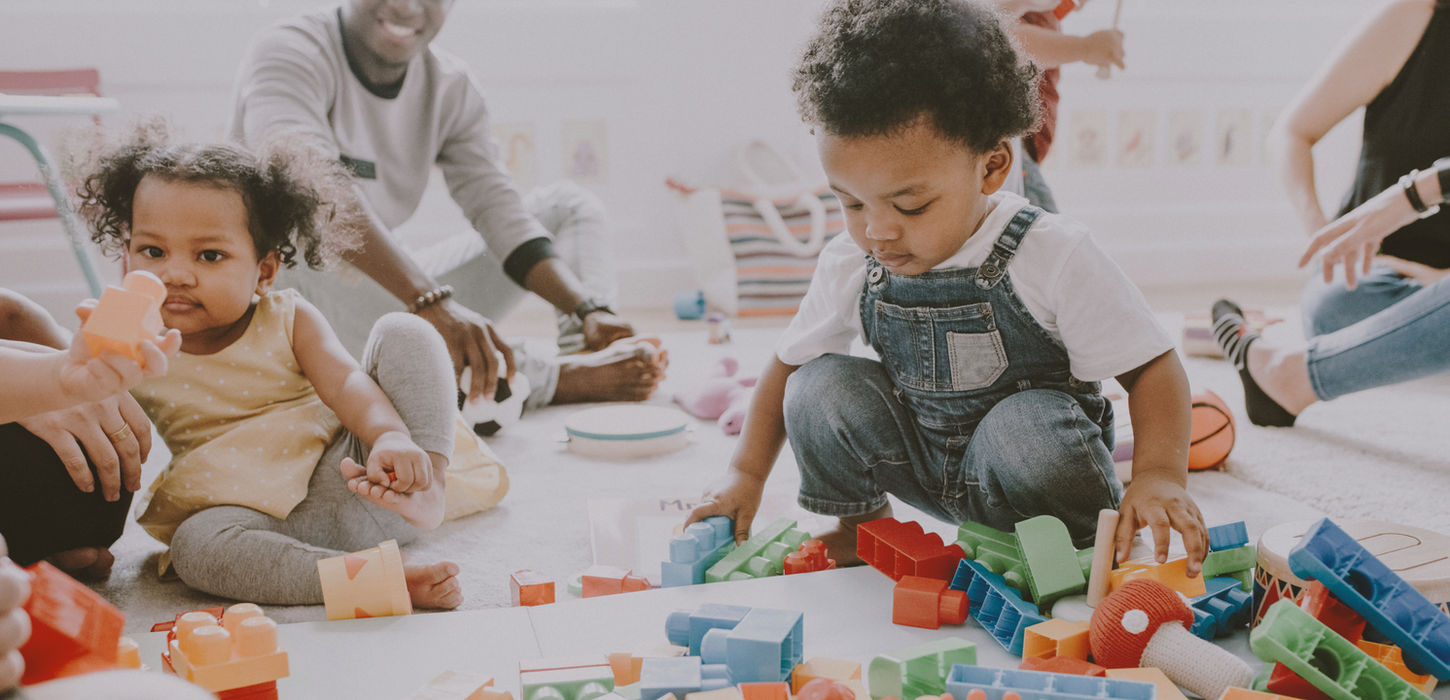 Children playing with colorful building blocks during educational activity