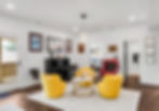 Modern living room with a black piano, yellow armchairs, and white rug