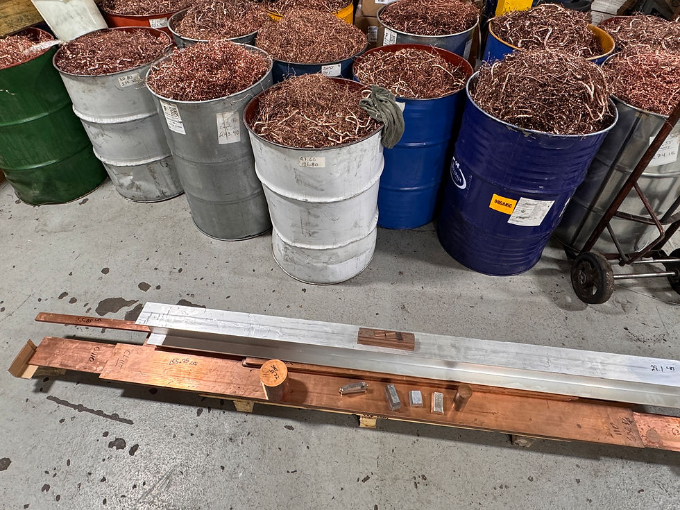 Industrial copper wire scrap in metal barrels with copper and aluminum metal bars
