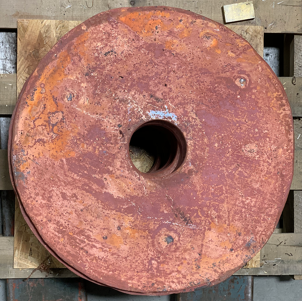 Large industrial copper component with natural patina oxidation on wooden pallets
