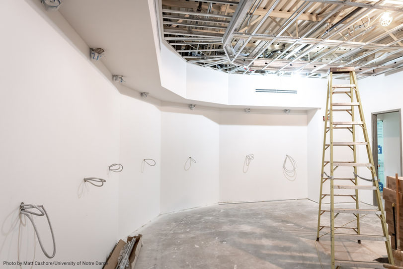 Construction phase showing white walls and exposed ceiling work