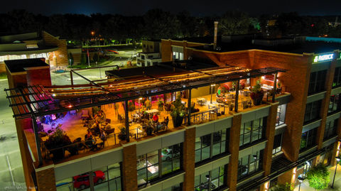 Rooftop dining area with outdoor seating and string lights
