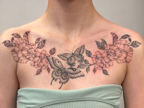 a chest piece featuring two butterflies and peonies