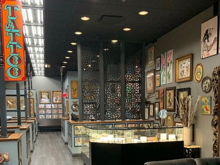 High angle view of a clean and well-lit tattoo shop interior with tattoo stations