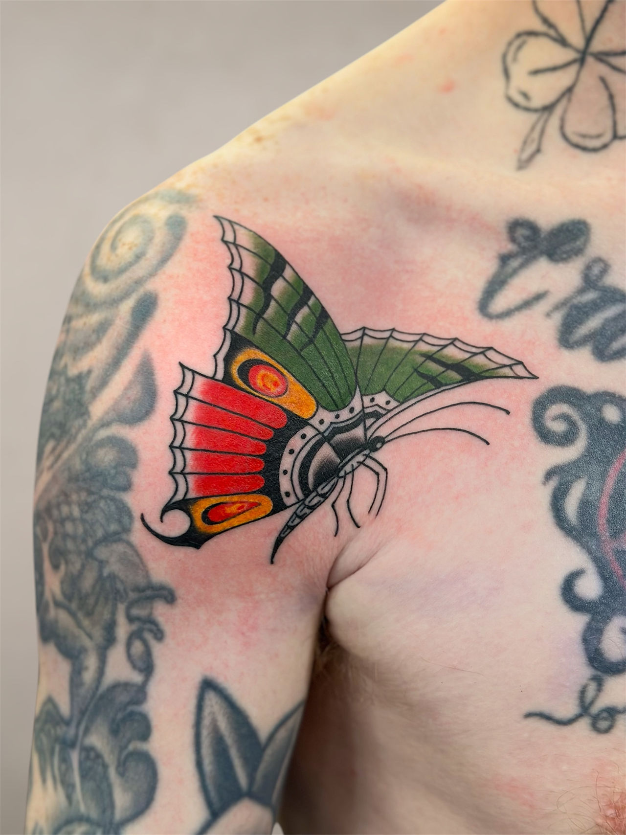 colorful butterfly tattoo on the shoulder 
