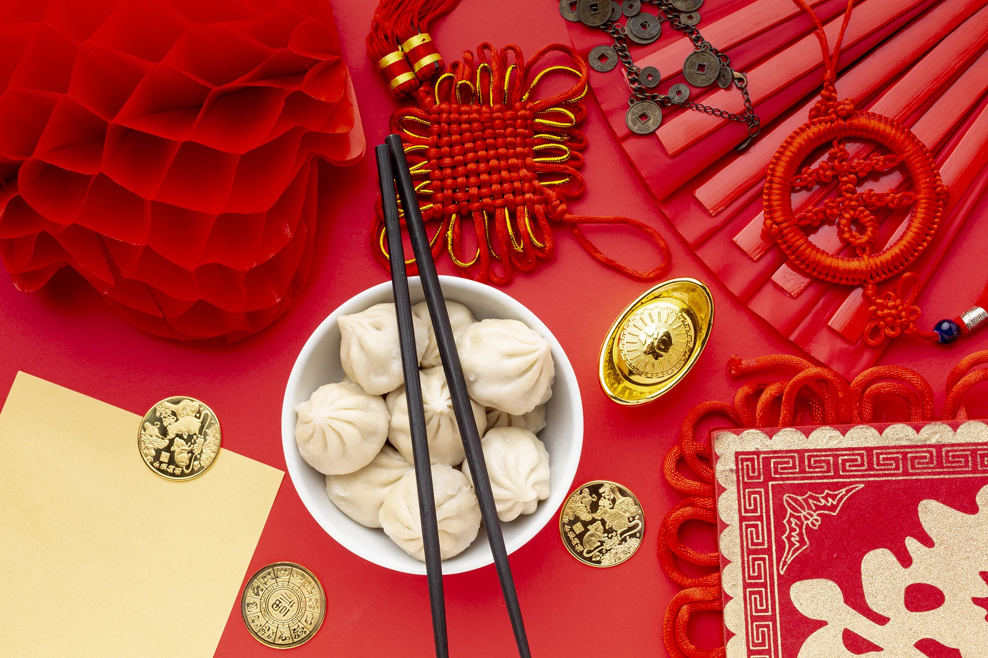 dumplings-with-chopsticks-and-lantern-chinese-new-year.webp