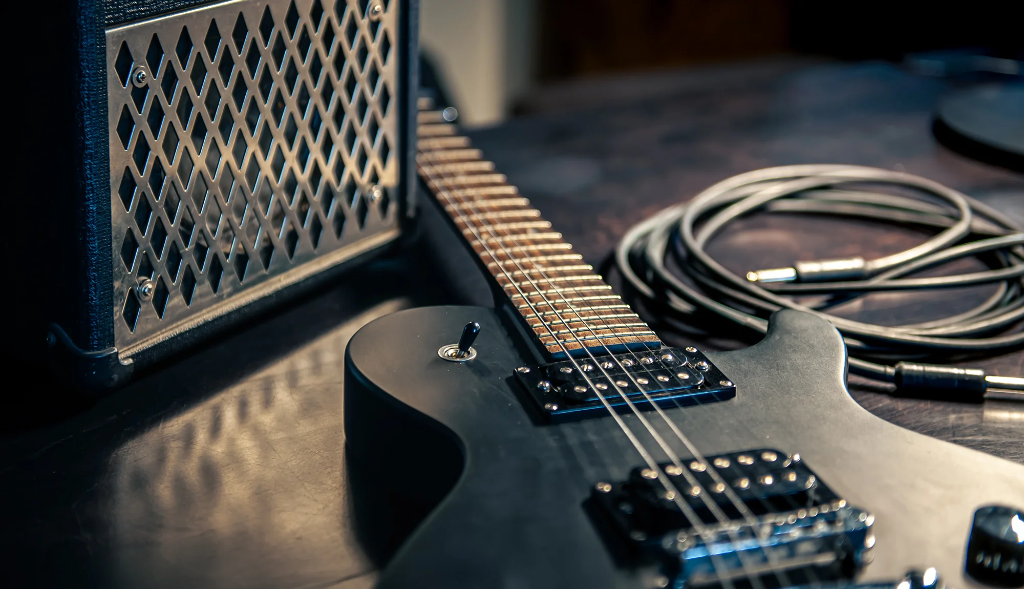 closeup-black-electric-guitar-on-dark-background.webp