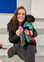Photo of a woman with a Dachshund crossbreed dog