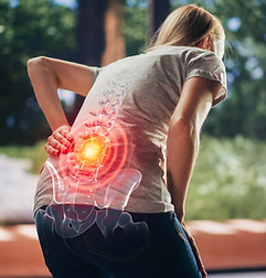 Woman bending over in discomfort, experiencing back pain symptoms, seeking professional help at New York Spinal Correction.