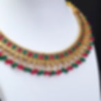 Detailed view of ruby square stud earring with beads.