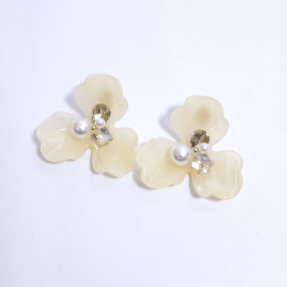 Three-petaled acrylic flower stud earrings with a central cluster of crystals and faux pearls in cream and light blue.