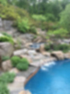 Backyard pool with spa and flowing water feature for added relaxation