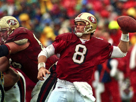Steve Young in a San Francisco 49ers uniform getting ready to throw a football