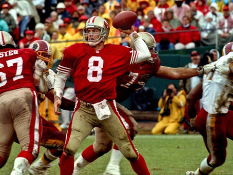 Picture of 49ers quarterback Steve Young in San Francisco 49ers uniform standing on football field, about to throw a football