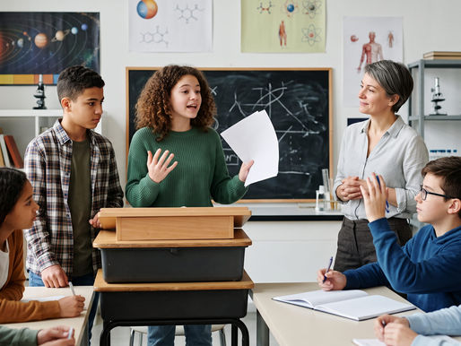 Students doing debate back and forth in a middle school science classroom.