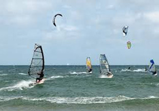 Windsurfers and kitesurfers on the seafront in Eastbourne