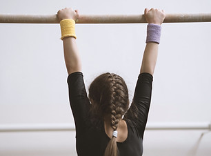 Gymnast on a Wooden Bar