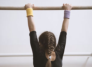 Gymnast on a Wooden Bar
