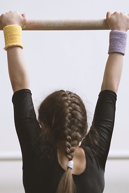 Gymnast on a Wooden Bar