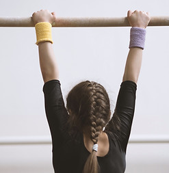 Gymnast on a Wooden Bar
