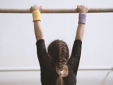 Gymnast on a Wooden Bar
