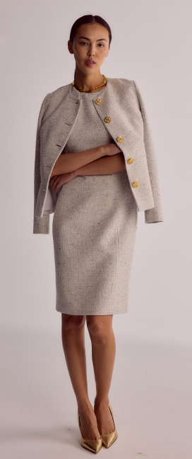woman in light pencil dress and jacket with gold buttons