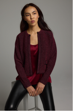 woman in black leather plants, wine colored shirt and sweater