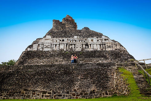 Two women posing with Xunantunich Ruins in the Background