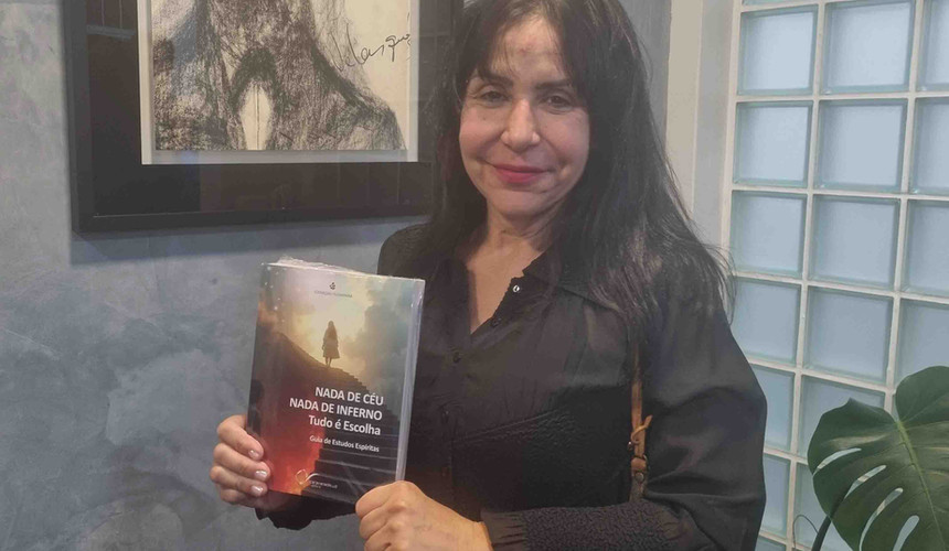Mulher adulta e alegre prestigia o lançamento do livro espírita Nada de Céu, Nada de Inferno: Tudo é Escolha.