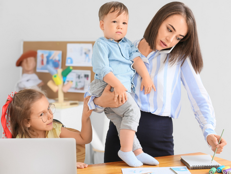A mother working her full-time job with children