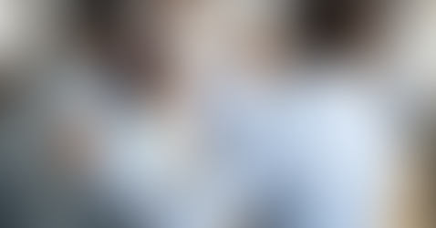 A boss puts his hands around his new hire in celebration