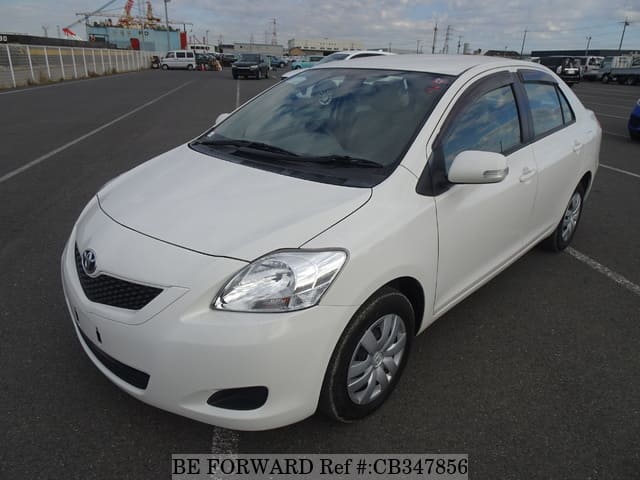 A grey JDM sports car speeding down a highway at night.