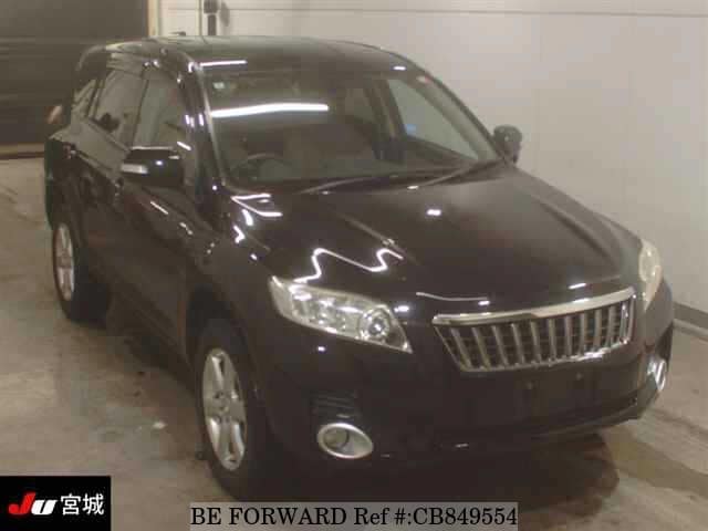 A grey JDM sports car speeding down a highway at night.