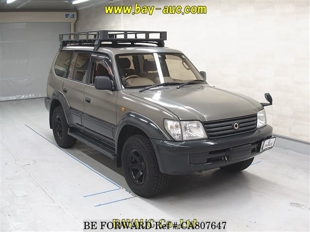 A grey JDM sports car speeding down a highway at night.