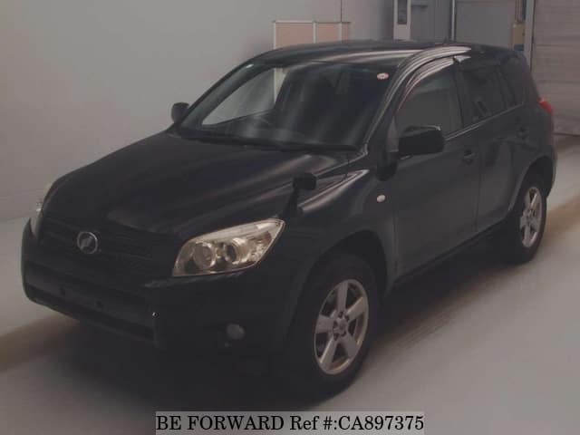 A grey JDM sports car speeding down a highway at night.