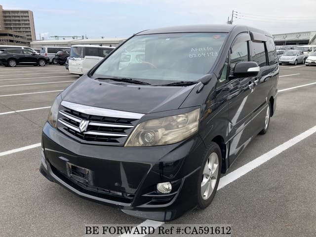 A grey JDM sports car speeding down a highway at night.