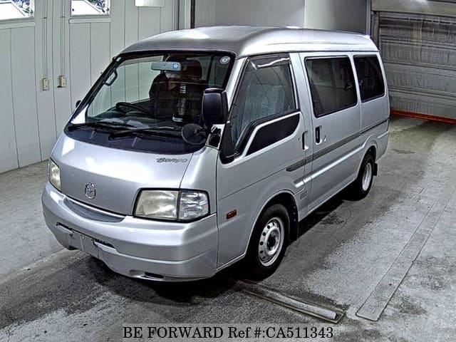 A grey JDM sports car speeding down a highway at night.